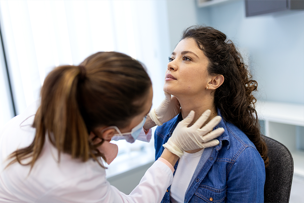 doctoring examining woman's thyroid