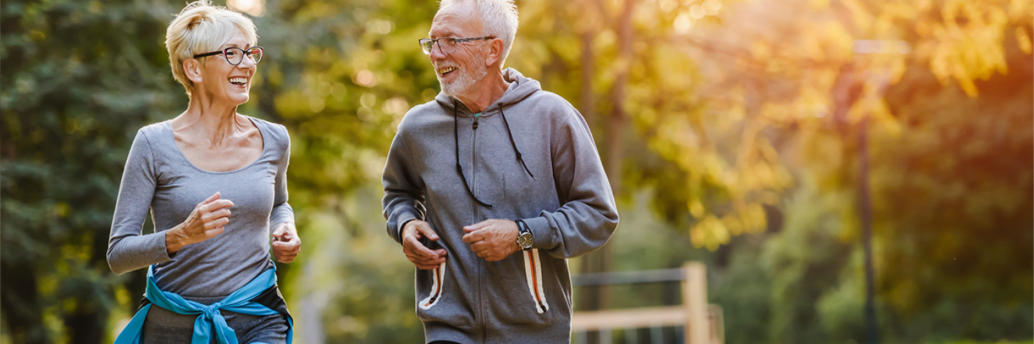 elderly couple walking in park